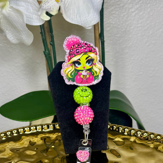 Cozy Lady Grinch Badge Reel